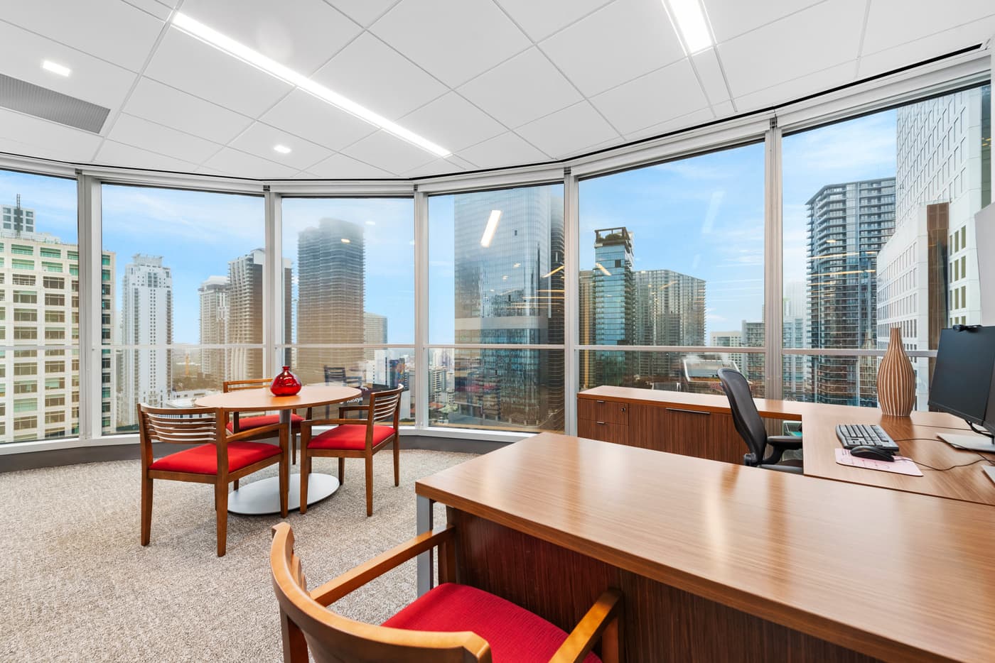 Sompo International's Miami office: reception lounge beneath a folded walnut ceiling with the Sompo wall sign, photograph 5
