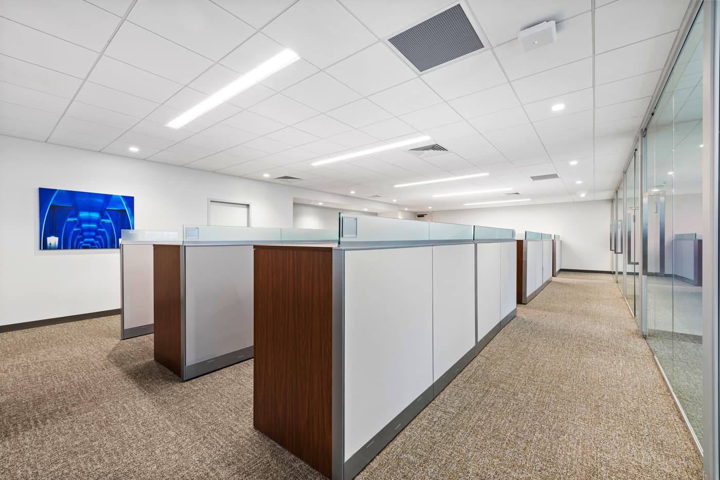 Sompo International's Miami office: reception lounge beneath a folded walnut ceiling with the Sompo wall sign, photograph 10