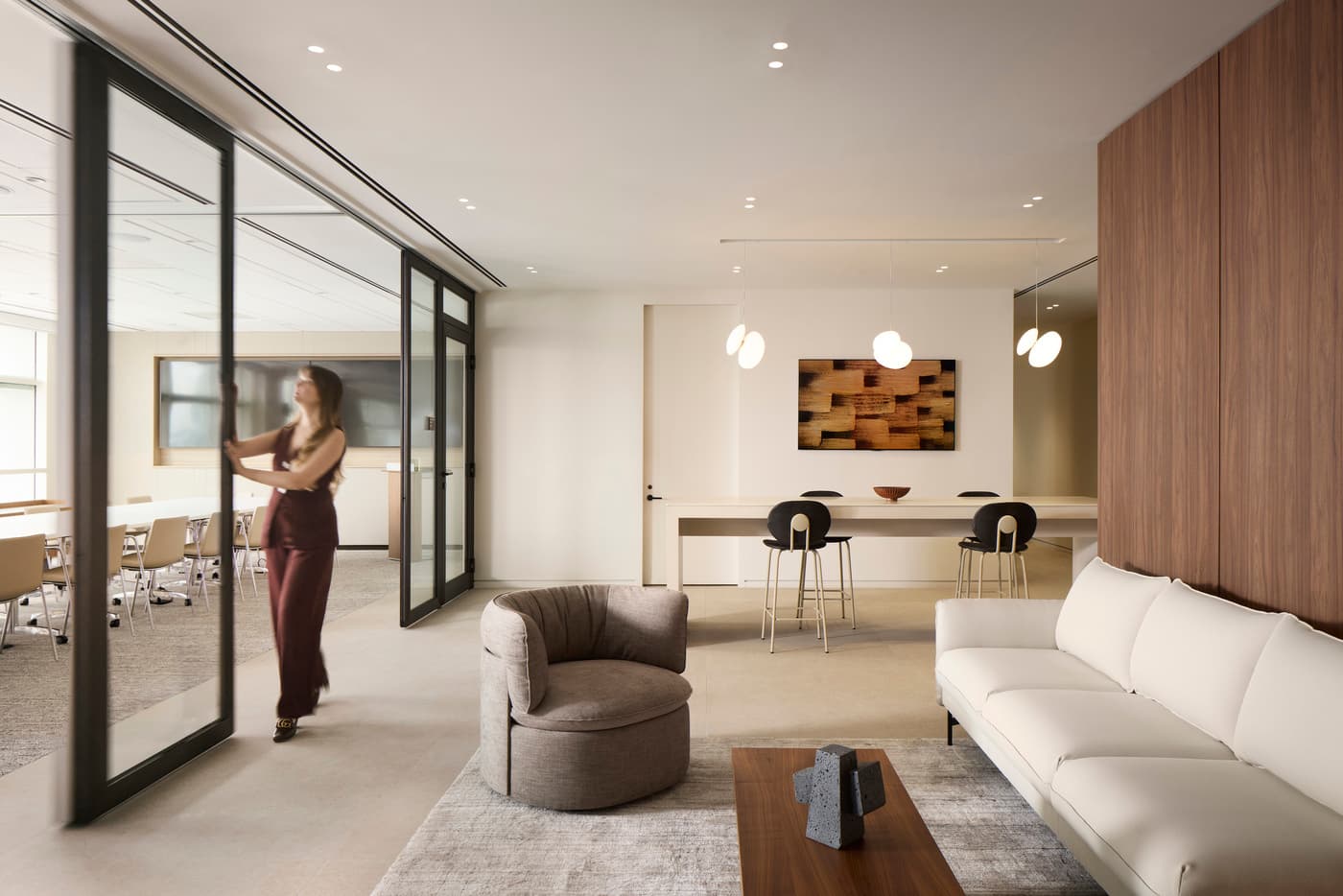 Venable's Miami office: reception with a marble desk beneath a coffered walnut ceiling, conference rooms beyond, photograph 5