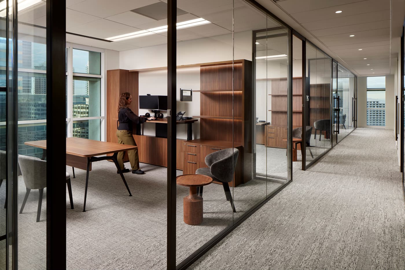 Venable's Miami office: reception with a marble desk beneath a coffered walnut ceiling, conference rooms beyond, photograph 10