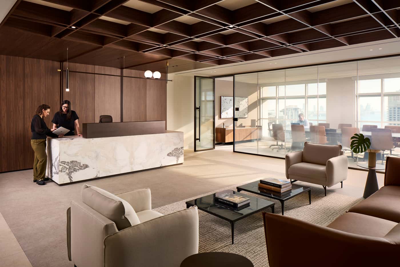 Venable's Miami office: reception with a marble desk beneath a coffered walnut ceiling, conference rooms beyond